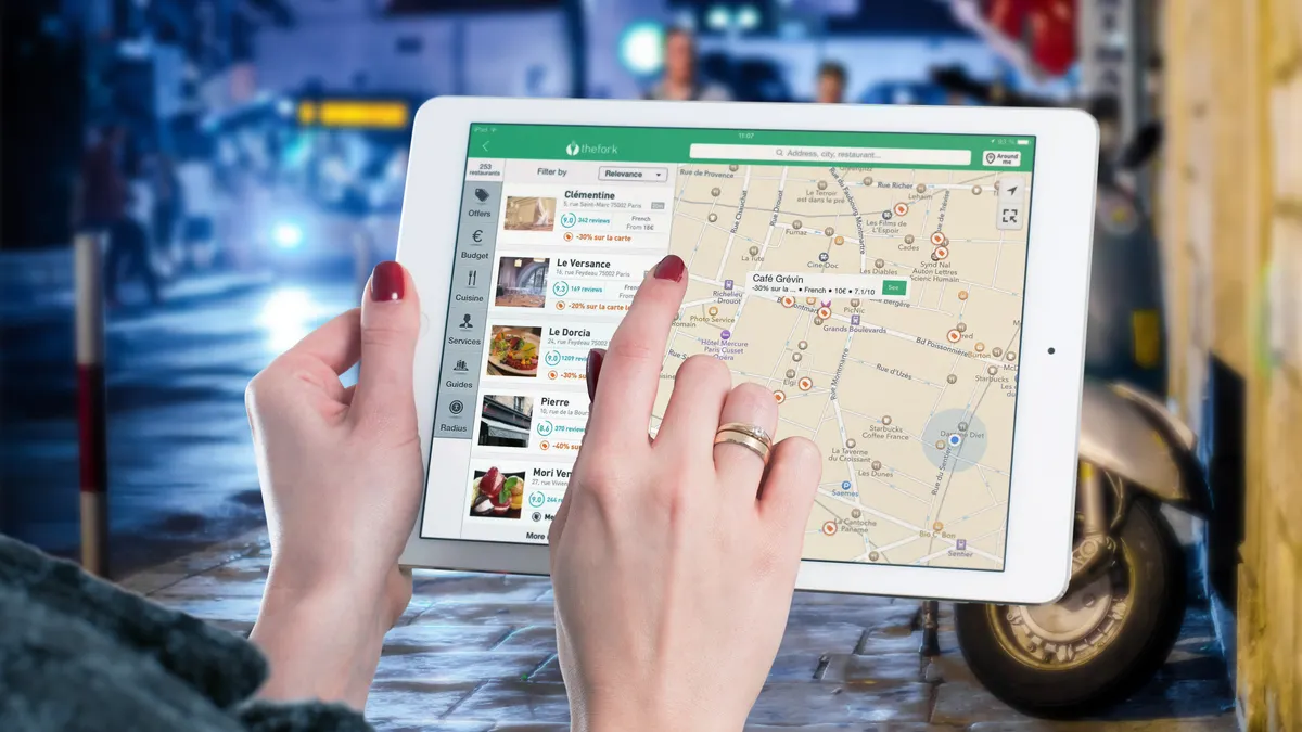 tablet displaying a map interface being tapped